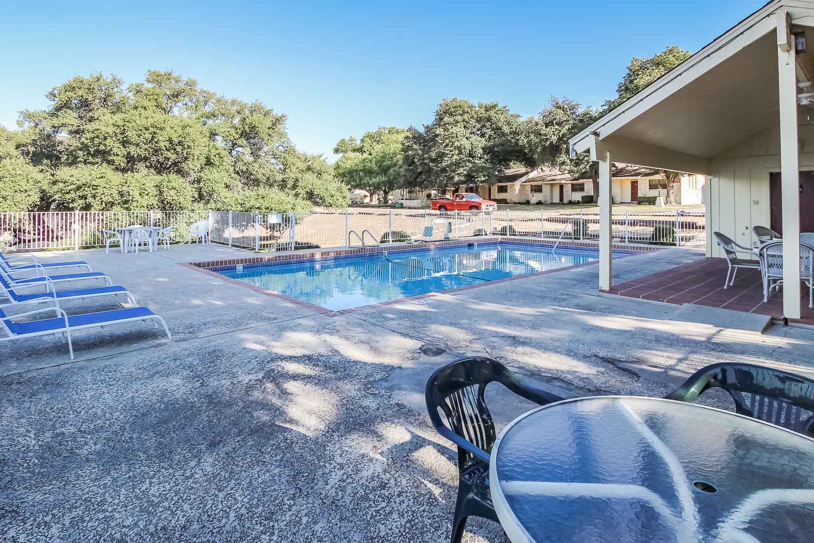 A peaceful outdoor swimming pool  at VRI's Vacation Village at Lake Travis in Texas.